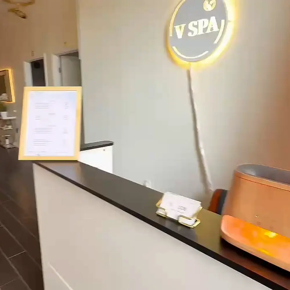 Calm and relaxing spa treatment room with a neatly made bed